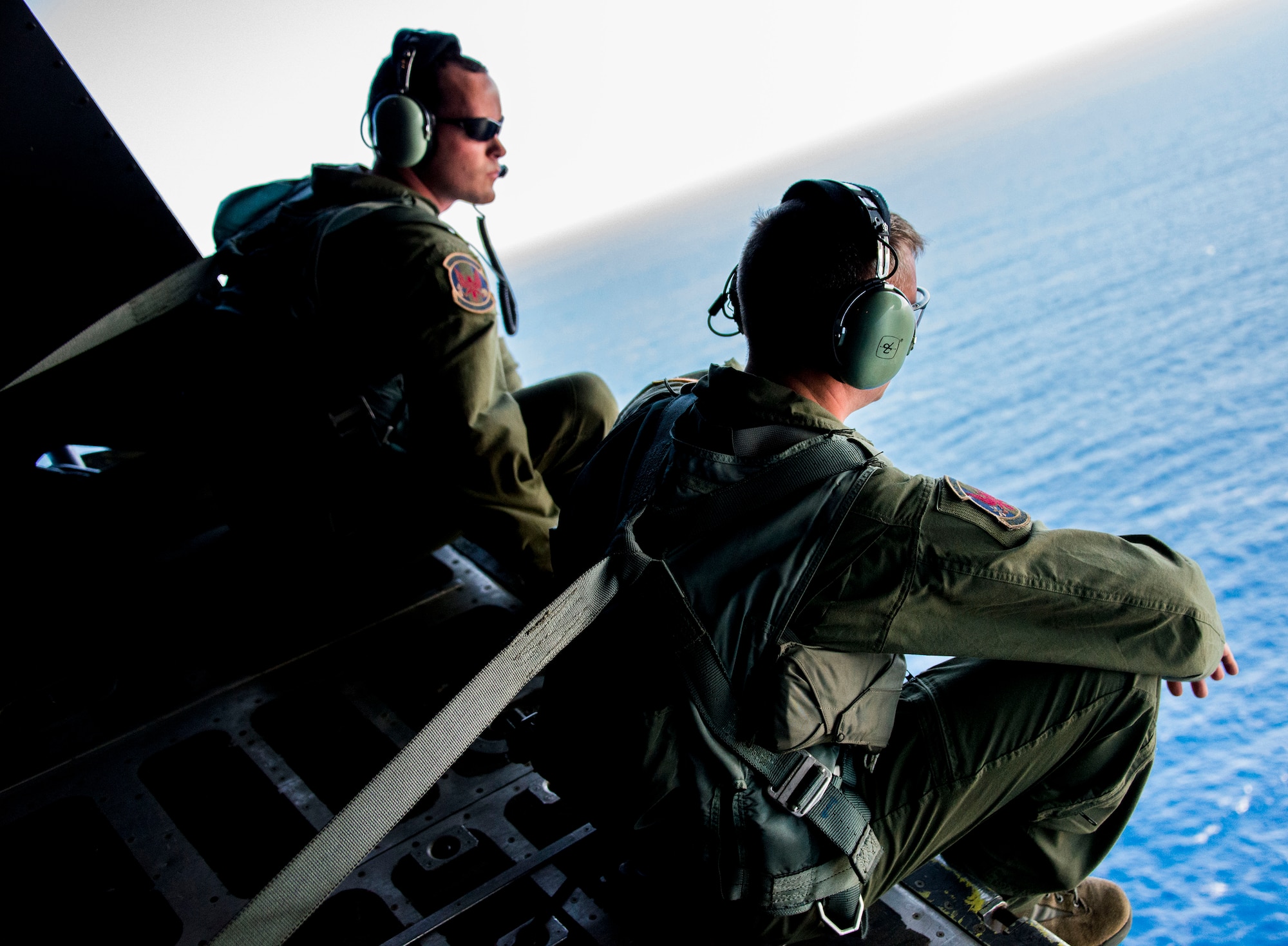 U.S. Air Force Staff Sgt. Zach Kelhi and Senior Airman Dan Stearns, 1st Special Operations Squadron Loadmasters, sit on the back of a U.S. Air Force MC-130H Combat Talon II special operations aircraft over Subic Bay, Philippines, Feb 26, 2013. Stray 59 was a 1st Special Operations Squadron U.S. Air Force MC-130E Combat Talon I special operations aircraft that went down in 1981 over Subic Bay, Philippines, during a training mission. (U. S. Air Force photo/Tech. Sgt. Kristine Dreyer)