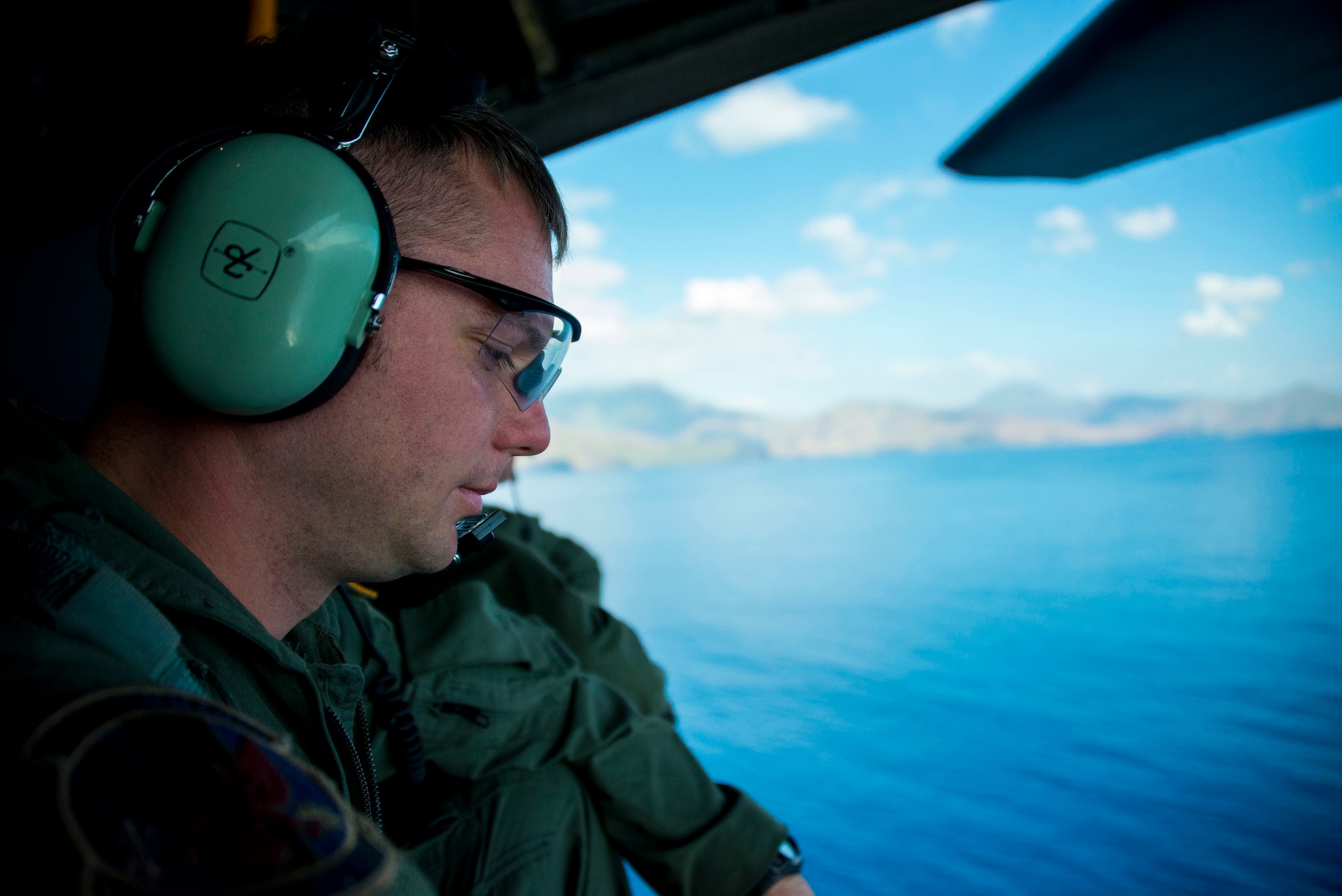 U.S. Air Force Staff Sgt. Zach Kelhi looks out at the crash site of Stray 59 over Subic Bay, Philippines, Feb 26, 2013. Stray 59 was a 1st Special Operations Squadron U.S. Air Force MC-130E Combat Talon I special operations aircraft that went down in 1981 over Subic Bay, Philippines, during a training mission. (U. S. Air Force photo/Tech. Sgt. Kristine Dreyer)