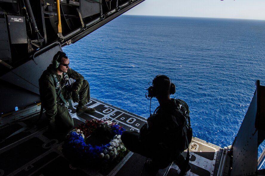 U.S. Air Force Staff Sgt. Zach Kelhi and Senior Airman Dan Stearns, 1st Special Operations Squadron loadmasters, prepare to air-drop a wreath off a U.S. Air Force MC-130H Combat Talon II special operations aircraft to memorialize Stray 59 over Subic Bay, Philippines, Feb. 26, 2013. Stray 59 was a 1st SOS U.S. Air Force MC-130E Combat Talon I special operations aircraft that went down in 1981 over Subic Bay, Philippines, during a training mission. (U. S. Air Force photo/Airman 1st Class Tyler Prince)