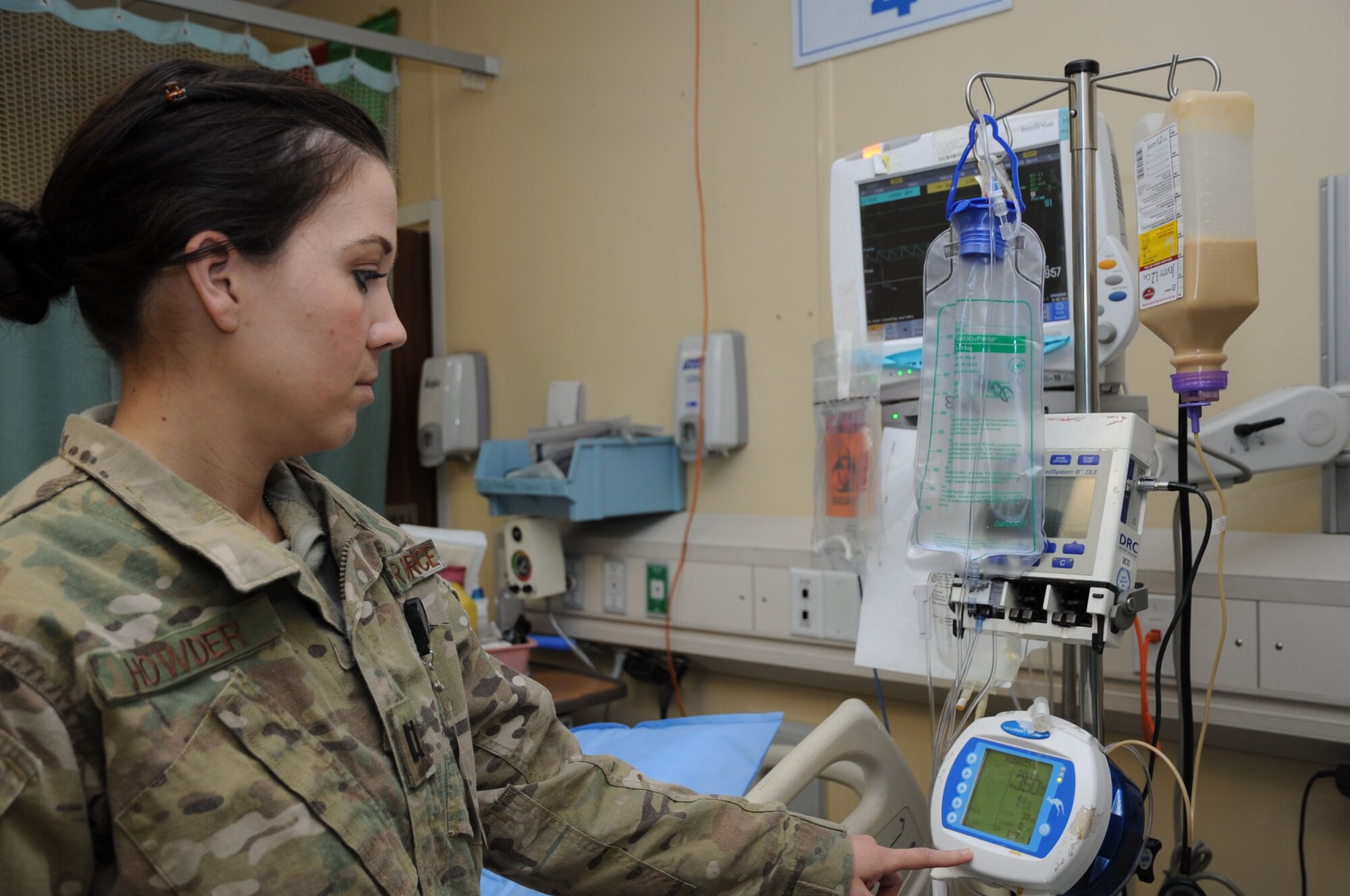 Capt. Lindzi Howder, 455th Expeditionary Medical Support Squadron nutritional medicine officer in charge, checks a patient's feeding equipment at the Craig Joint Theater Hospital on Bagram Airfield, Afghanistan, March 5, 2013. Howder is responsible for all facets of patient and staff feeding at the CJTH. (U.S. Air Force photo/Staff Sgt. David Dobrydney)