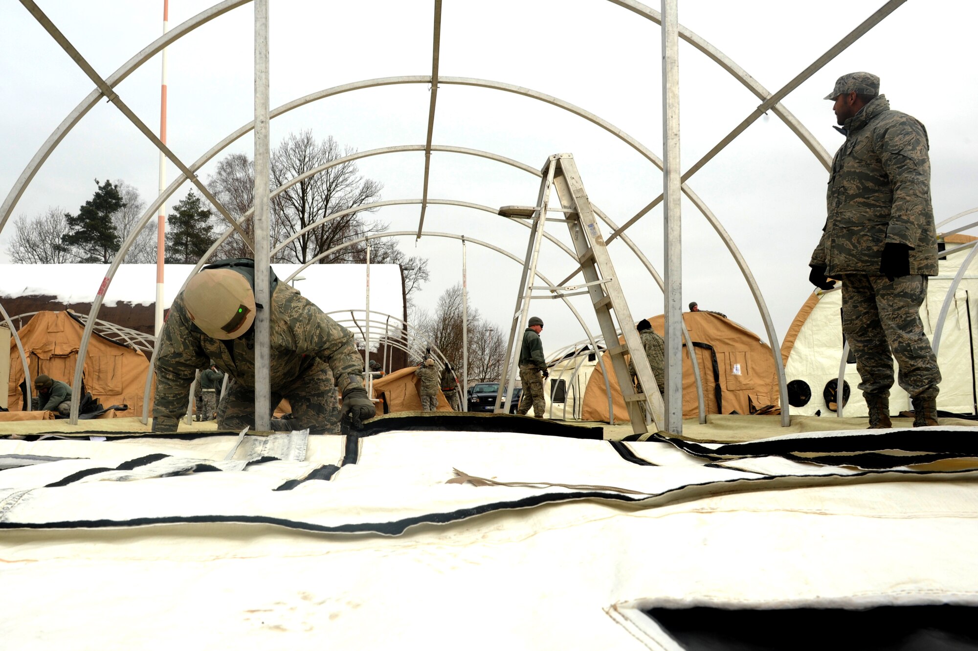Airmen assemble tents during the Silver Flag training exercise March 5 on Ramstein Air Base, Germany. The purpose of Silver Flag is to prepare Airmen for any type of bare-base deployment. (U.S. Air Force photo/Senior Airman Aaron-Forrest Wainwright)