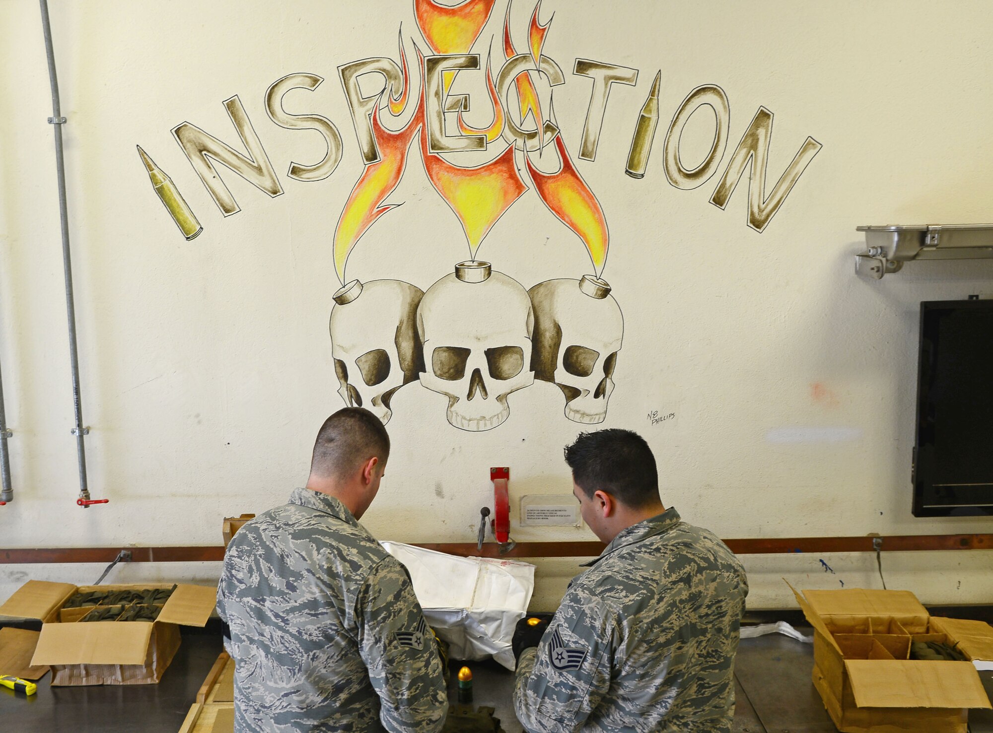 Senior Airman Austin Husome and Staff Sgt. Luis Soto, 31st Munitions Squadron inspectors, perform a quality check on 40 mm HE grenades, Feb. 26, 2013 at Aviano Air Base, Italy. The 31st MUNS is accountable for four different stockpiles of munitions valued at nearly $800 million. (U.S. Air Force photo/Airman 1st Class Matthew Lotz)