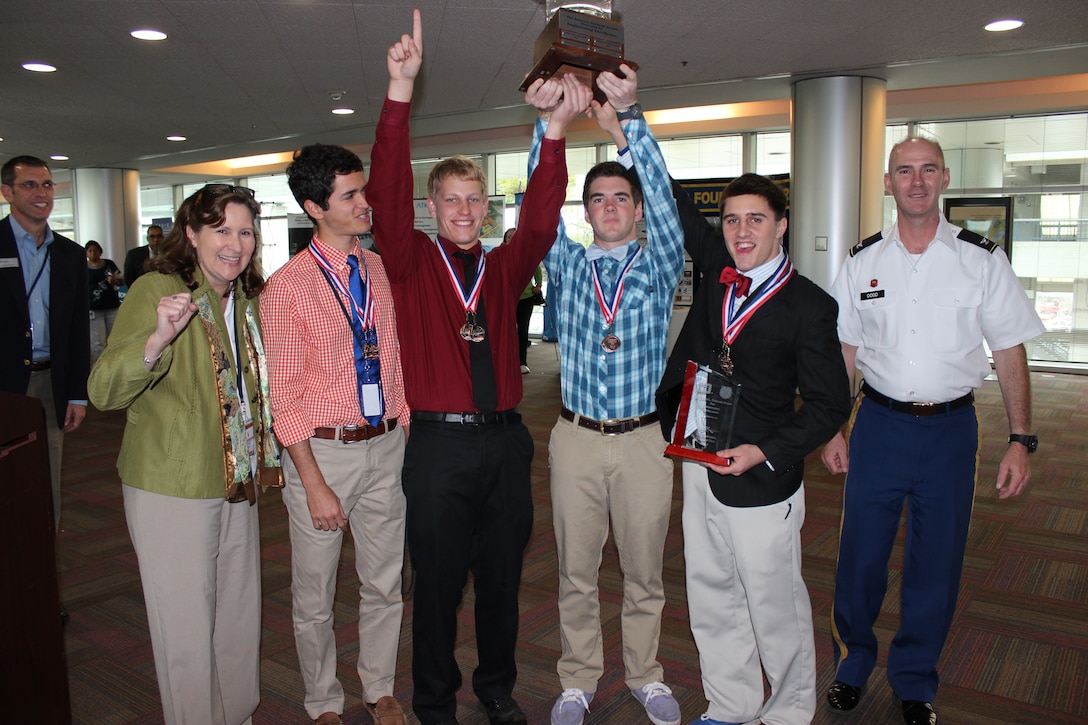 The Thunder Buddies from Bishop Kenny High School celebrate after they are named overall winners of the Engineering Career Day competition. Left to right is teacher Vicki Schmitt with team members Peter House, Stephen Baltz, Michael Barr and Zach McNulty accepting the James L. Garland trophy from Col. Alan Dodd, district commander. 