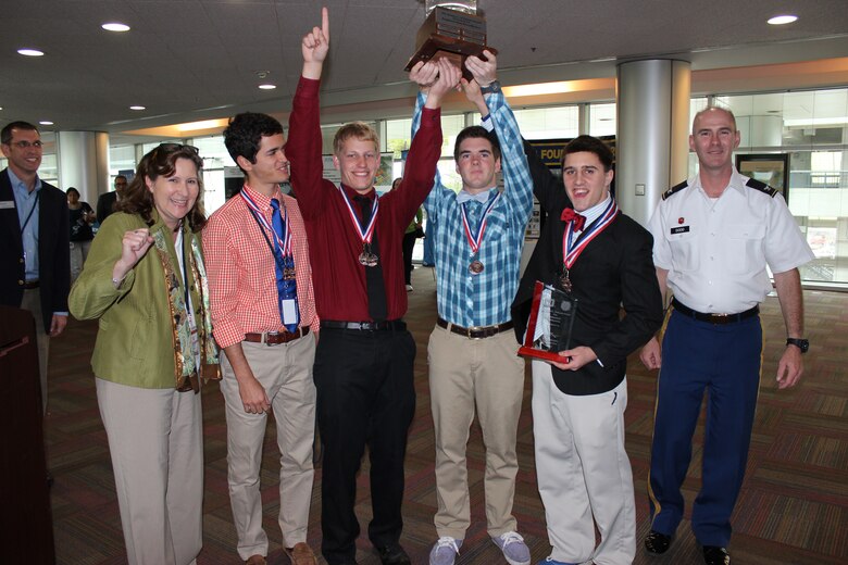 The Thunder Buddies from Bishop Kenny High School celebrate after they are named overall winners of the Engineering Career Day competition. Left to right is teacher Vicki Schmitt with team members Peter House, Stephen Baltz, Michael Barr and Zach McNulty accepting the James L. Garland trophy from Col. Alan Dodd, district commander. 