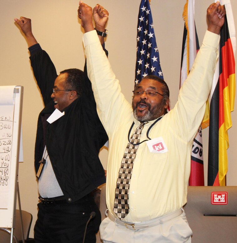Carlos Clarke (left) and Robert Meekie, Contracting Division, celebrate their victory as 2013 Brain Brawl champions. Photo by Christina Swanson.