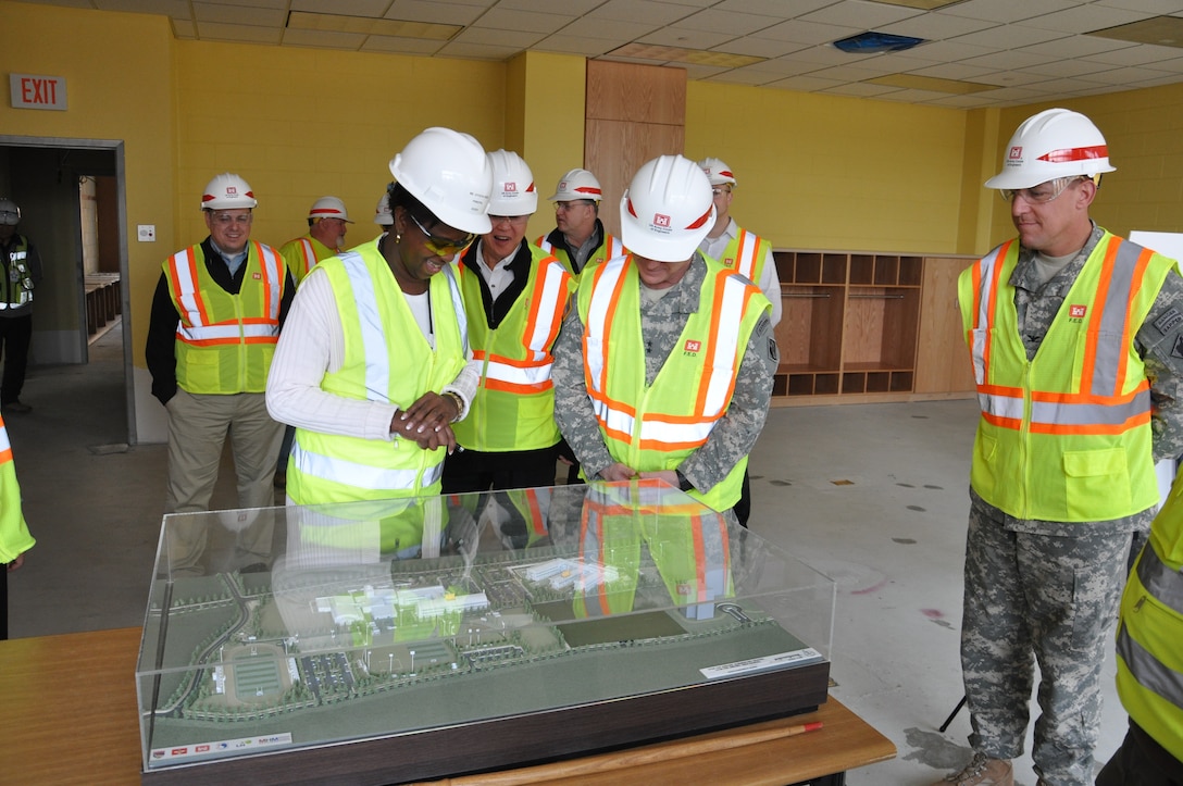 Maj. Gen. Kendall Cox (center), U.S. Army Corps of Engineers deputy commanding general for military and international operations, looks at a scale model of the new elementary and high school project at U.S. Army Garrison Humphreys March 6.  The future principal of the elementary school (left) looks on.  This was Cox’s first visit to the elementary school project.  (Photo by Joe Campbell)