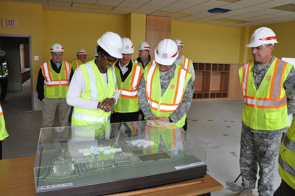 Maj. Gen. Kendall Cox (center), U.S. Army Corps of Engineers deputy commanding general for military and international operations, looks at a scale model of the new elementary and high school project at U.S. Army Garrison Humphreys March 6.  The future principal of the elementary school (left) looks on.  This was Cox’s first visit to the elementary school project.  (Photo by Joe Campbell)