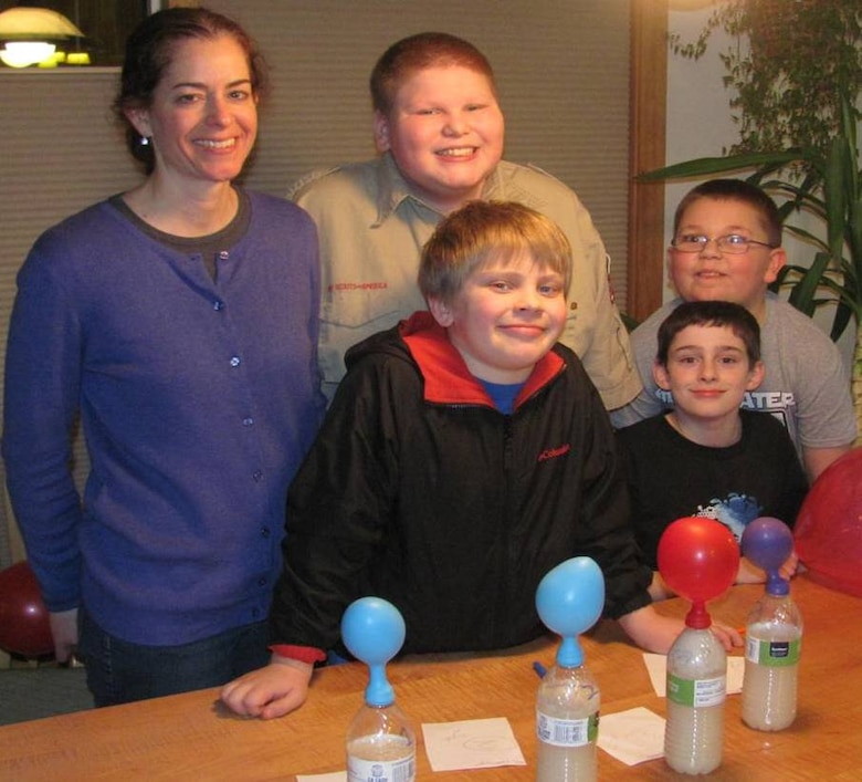 Beth Astley, program manager in the Environmental and Special Programs Branch, mentors Webelos by helping them earn the scientist activity badge by conducting an experiment using yeast, sugar and water.