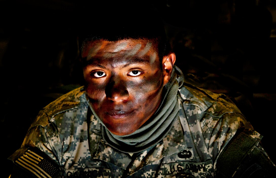 Army Pvt. 1st Class Francisco Garnica waits in full face paint to participate in a jump exercise on Fort Bragg, N.C., Feb. 23, 2013. Face paint helps break up skin color, which helps for tactical exercises or night jumps. Garnica is assigned to the 161st Engineer Support Company Combat Airborne.