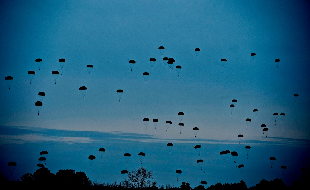 Soldiers parachute during a jump exercise involving 1,700 parachutes on Fort Bragg, N.C., Feb. 25, 2013. 