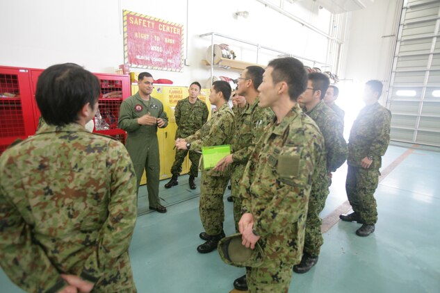 Gunnery Sgt. Nathan K. Lanham, an Aircraft Rescue Firefighting section leader, leads a tour for Japan Ground Self Defense Force soldiers of ARFF facilities here Feb. 28, 2013.