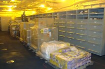 Pallets of office supplies sit in a warehouse aboard the USNS Robert E. Peary.  A detachment of Marines with 2nd Supply Battalion, 2nd Marine Logistics Group deployed to replenish the 26th Marine Expeditionary Unit from Feb. 7 to 17, 2013.  The four Marines from 2nd Supply Bn. utilized a new supply system through the Navy. 
