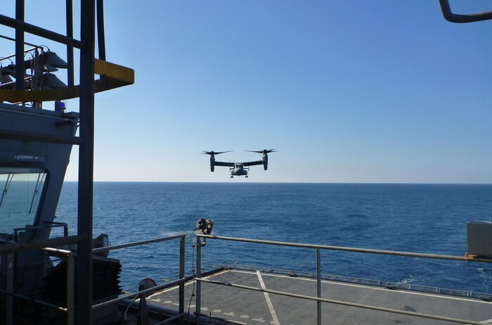 A naval aircraft assists a detachment of Marines from 2nd Supply Battalion, 2nd Marine Logistics Group to replenish the 26th Marine Expeditionary Unit. The detachment of four Marines aboard the USNS Robert E. Peary utilized a new supply system through the Navy from Feb. 7 to 17, 2013. 