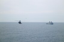 Two naval aircrafts assist with a detachment of Marines from 2nd Supply Battalion, 2nd Marine Logistics Group to replenish the 26th Marine Expeditionary Unit. The detachment of four Marines aboard the USNS Robert E. Peary utilized a new supply system through the Navy from Feb. 7 to 17, 2013. 