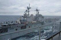 One of the naval vessels attached to the 26th Marine Expeditionary Unit awaits the arrival of the Marines from 2nd Supply Battalion, 2nd Marine Logistics Group for replenishment. As the ship arrived, four Marines aboard the USNS Robert E. Peary utilized a new supply system to restock the 26th.