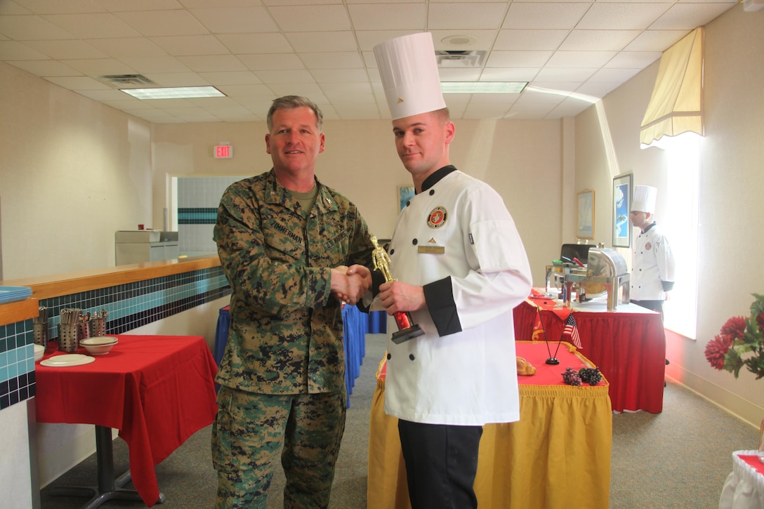 Col. Philip J. Zimmerman, commanding officer of Marine Corps Air Station Cherry Point, presents the first-place trophy to Lance Cpl. Timothy J. Bruce, a food service specialist with Headquarters and Headquarters Squadron, for the Chef of the Quarter competition. Winning by only a half point, Bruce’s overall food presentation, attention to detail and cleanliness in the kitchen helped him secure victory over his counterparts.

