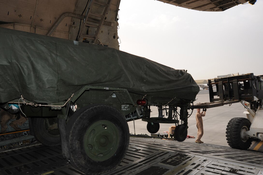 Staff Sgt. Matthew Dolan, a loadmaster assigned to Travis Air Force Base unloads an AN/TPS-59 from a C-5 Galaxy at an undisclosed base in Southwest Asia Feb. 28, 2013. The AN/TPS-59 is dual-purpose long range radar deployed to the region in support of U.S. Air Forces Central Command’s Integrated Air Defense and Missile shield. The AN/TPS-59 is one of the U.S. military’s most powerful radars and the systems inherit mobility allows for rapid worldwide deployment. The radar will be operated by Marines from 3rd Marine Aircraft Wing, Marine Air Control Group 38, Marine Air Control Squadron 1, based in Yuma, Ariz.
