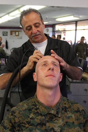 A recruit of Company B, 1st Recruit Training Battalion, receives his weekly buzz-cut aboard Marine Corps Recruit Depot San Diego Feb. 12. Haircuts are just one piece of an overall professional appearance recruits learn from their drill instructors. 