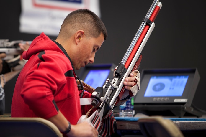 Sgt. Anthony A. Arriaga, an athlete with Team West, wipes his weapon during the Marine Corps Trial’s shooting competition here March 4.