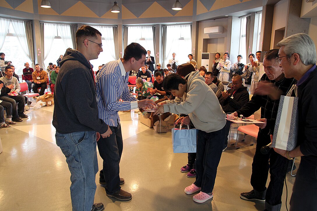 Marines and sailors present gifts to residents of Asaina-Gakuen facility March 2 in Sendai, Miyagi prefecture, Japan. Marines and sailors also visited orphanages and schools in the Sendai area, one of many visits since Operation Tomodachi that a Marine Corps unit or senior Marine Corps leaders have made to the Sendai area. The Marines and sailors are with Alpha Battery, currently assigned to 3rd Battalion, 12th Marine Regiment, 3rd Marine Division, III Marine Expeditionary Force, under the unit deployment program. 
