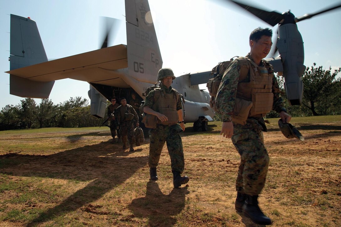 Japan Ground Self-Defense Force officers and Marines disembark an MV-22B Osprey March 1 at the Central Training Area near Camp Hansen. The JGSDF officers were given the opportunity to experience flying in the MV-22B Osprey for the first time and learned about the aircraft’s capabilities. The Marines are with Combat Assault Battalion, 3rd Marine Division, III Marine Expeditionary Force.