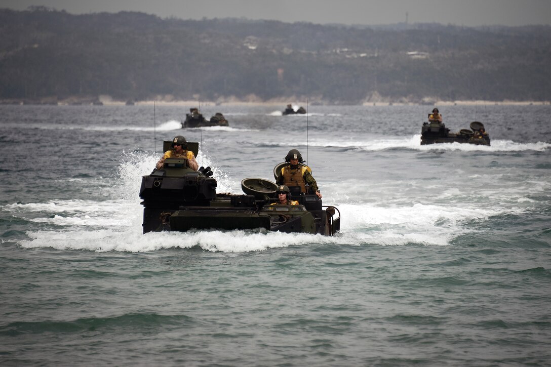 Marines maneuver assault amphibious vehicles through the water in formation March 5 at Camp Schwab. The Marines used the training evolution to work on communication and teamwork between AAV crews. The Marines are with 4th platoon, Company C, 2nd Assault Amphibian Battalion, 2nd Marine Division, currently assigned to AAV Company, Combat Assault Battalion, 3rd Marine Division, III Marine Expeditionary Force, under the unit deployment program. 
