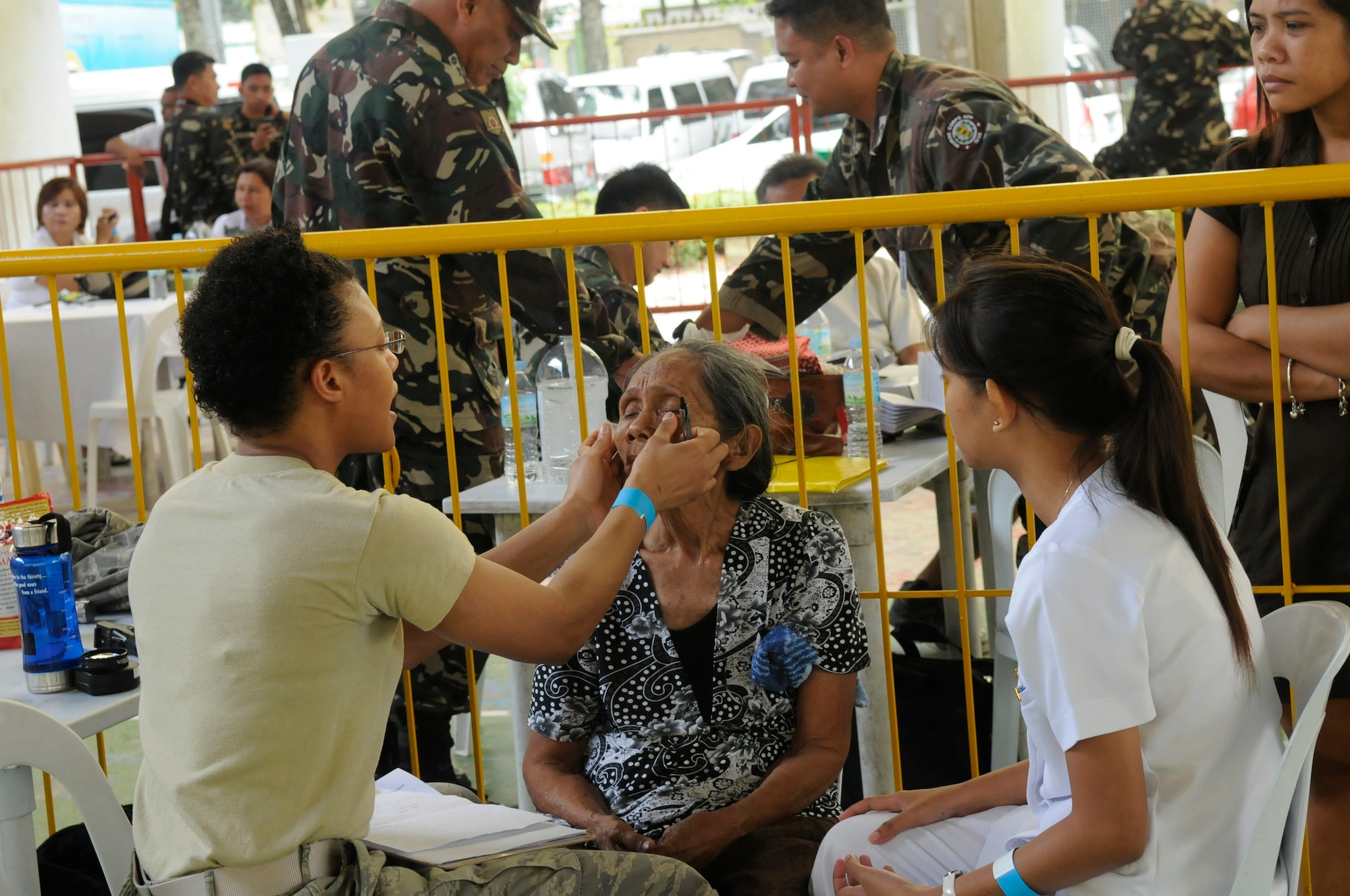 U.S. Air Force Capt. Falicia Jackson and a volunteer nurse treat an optometry patient at the Operation Pacific Angel-Philippines medical site at Tanjay March 5, 2013. American and Filipino doctors treated hundreds of patients each day during the mission. Jackson is an optometrist from Osan Air Base, South Korea. Operation Pacific Angel is a joint and combined humanitarian assistance exercise held in various countries several times a year and includes medical, dental, optometry, engineering programs and various subject-matter expert exchanges. (U.S. Air Force photo/Senior Master Sgt. J.C. Woodring) 