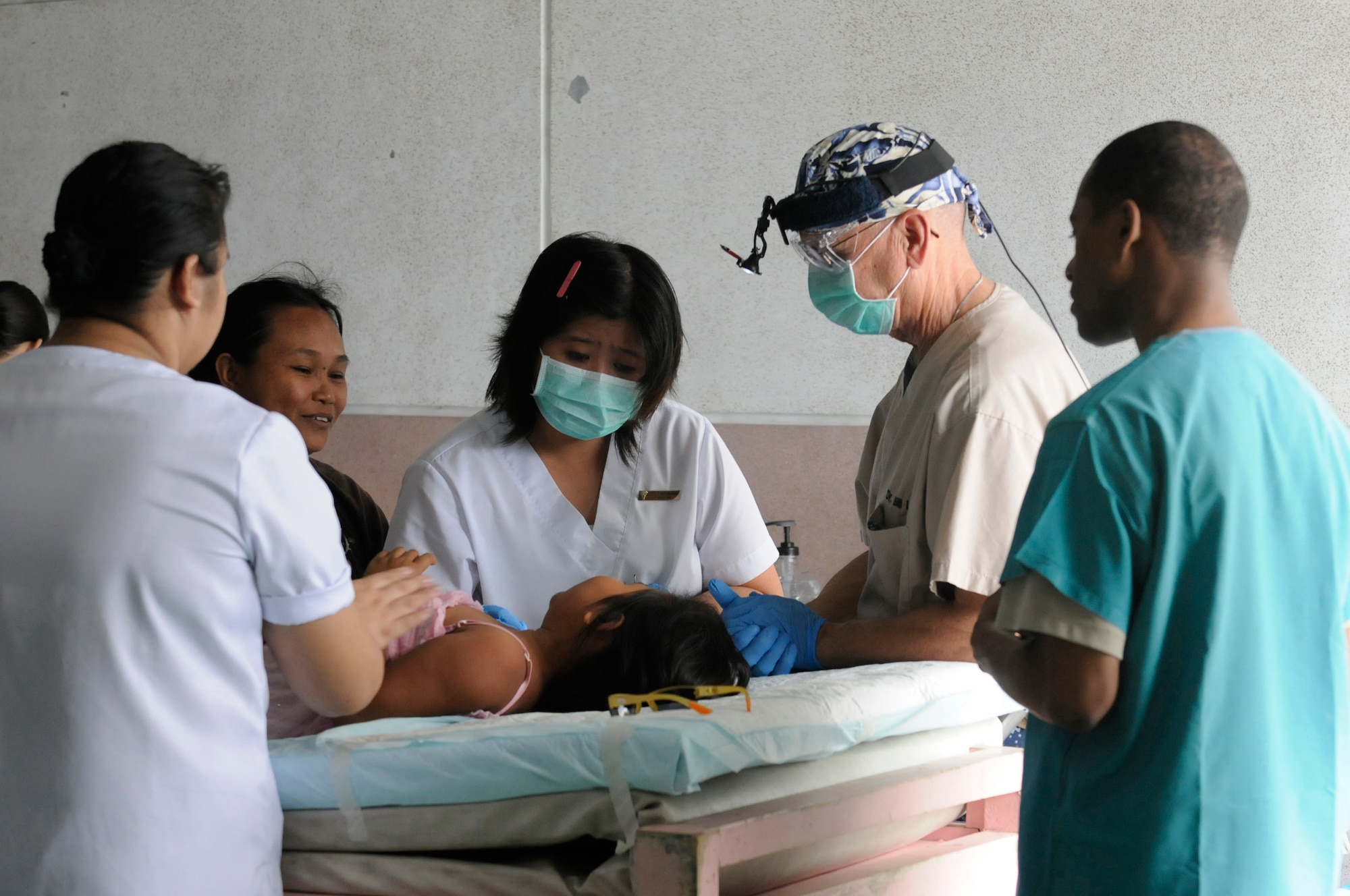 U.S. Navy Cmdr. Bill Lyons and a volunteer nurse treat an optometry patient at Operation Pacific Angel-Philippines medical site at Dumaguete on March 4, 2013. American and Filipino doctors treated hundreds of patients each day during the mission. Lyons is a dentist from Camp Pendelton, Calif. Operation PACANGEL is a joint and combined humanitarian assistance exercise held in various countries several times a year and includes medical, dental, optometry, engineering programs and various subject-matter expert exchanges. (U.S. Air Force photo/Senior Master Sgt. J.C. Woodring)  