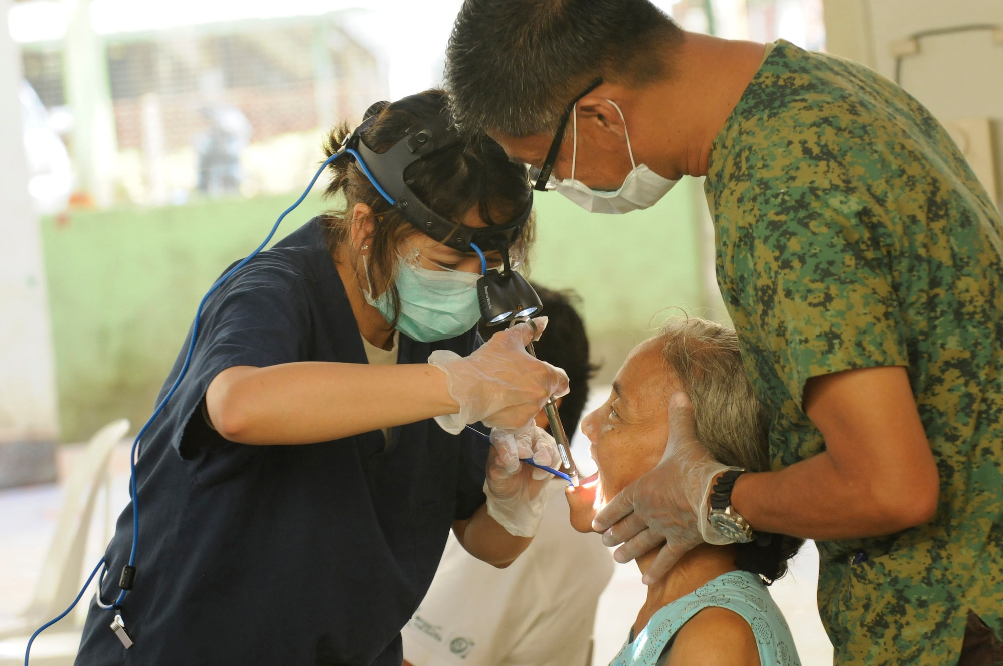 U.S. Air Force Capt. (Dr.) Cherie Gabriel and an Armed Forces of the Philippines counterpart treat a dental patient at the Operation Pacific Angel-Philippines medical site at Tanjay on March 4, 2013. American and Filipino doctors treated hundreds of patients each day during the mission. Gabriel is a dentist from Yokota Air Base, Japan. Operation Pacific Angel is a joint and combined humanitarian assistance exercise held in various countries several times a year and includes medical, dental, optometry, engineering programs and various subject-matter expert exchanges. (U.S. Air Force photo by Senior Master Sgt. J.C. Woodring) (Not Released)