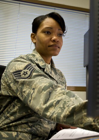 Staff Sgt. Tarheisha Alvarez, 99th Force Support Squadron force management supervisor, updates an Airman's profile Mar. 7, 2013, at Nellis Air Force Base, Nev. Originally from Chicago, Ill., Alvarez oversees enlisted and officer performance evaluations. (U.S. Air Force photo by Airman 1st Class Christopher Tam)
