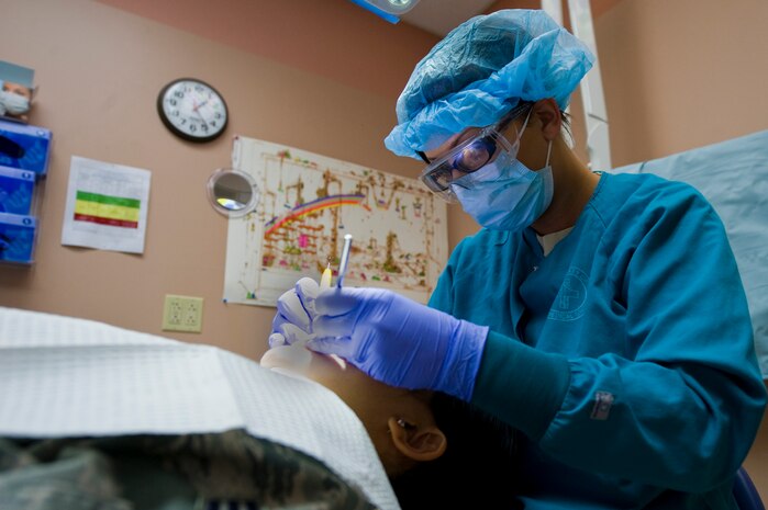 U.S. Air Force Senior Airman Jessica Peterson, 99th Dental Squadron dental assistant, cleans a patient's teeth Mar. 6, 2013, at Nellis Air Force Base, Nev. Originally from Flint, Mich., Peterson makes sure everyone is up to date on their oral hygiene by cleaning their teeth and scheduling necessary appointments. (U.S. Air Force photo by Airman 1st Class Christopher Tam)