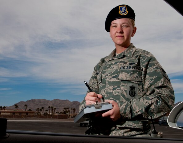 U.S. Air Force Staff Sgt. Brittany Rumsey, 99th Security Forces Squadron patrolman, issues a traffic citation March 6, 2013, at Nellis Air Force Base, Nev. Originally from Concord, Calif., Rumsey is assigned to the S3OA2 operations flight of the 99th SFS. (U.S. Air Force photo by Master Sgt. Jason W. Edwards)