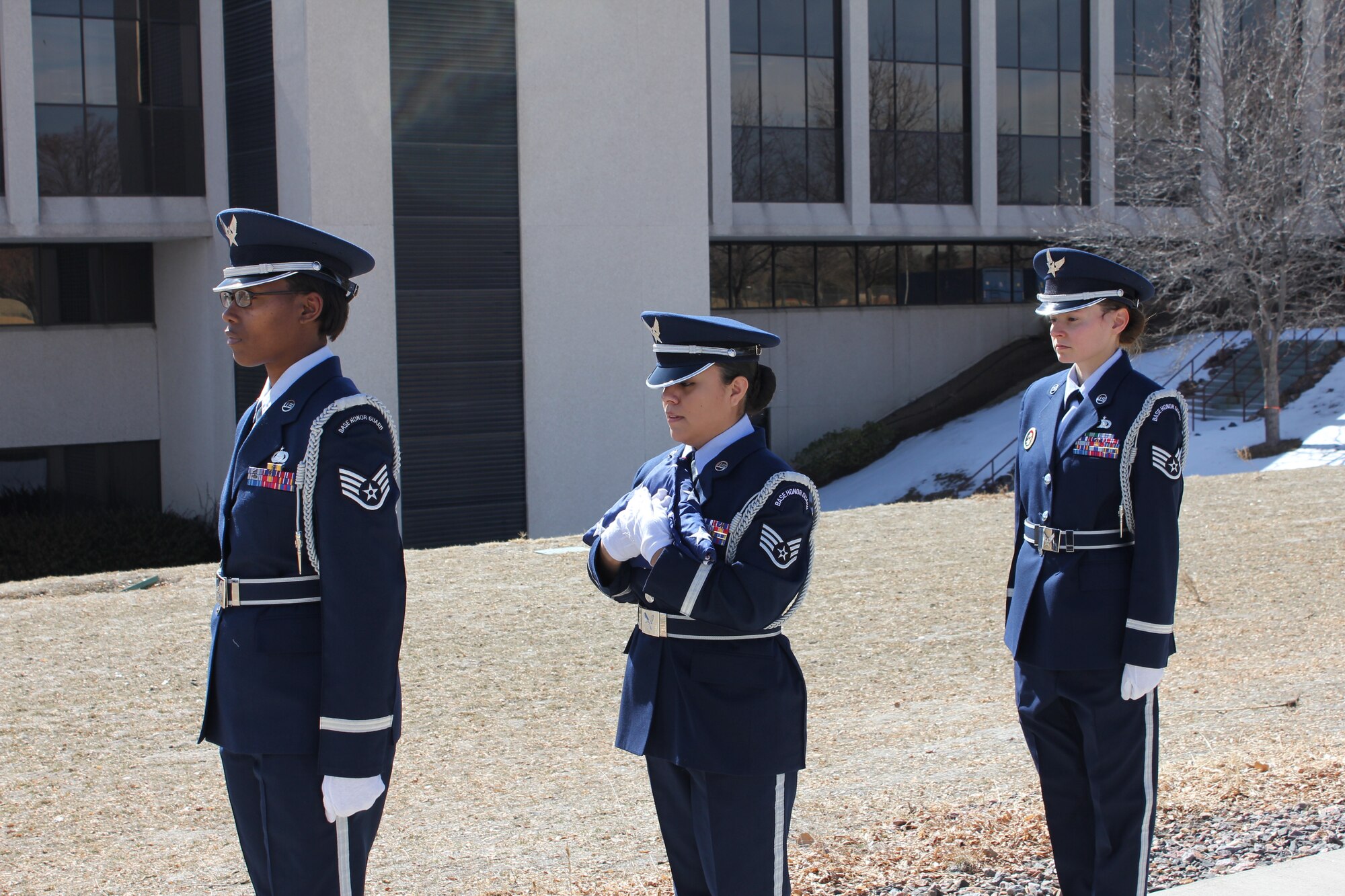 Members of the Air Reserve Personnel Center Honor Guard, Staff Sgts. Cindy Rodriguez, Letitia Edwards and Ashley Kidder, prepare to fly a U.S. flag over the former ARPC building in Denver today. The flag ceremony honored the retirement of the center's 29th commander, Maj. Gen. Eric Crabtree. (U.S. Air Force photo/Cindy Dewey)