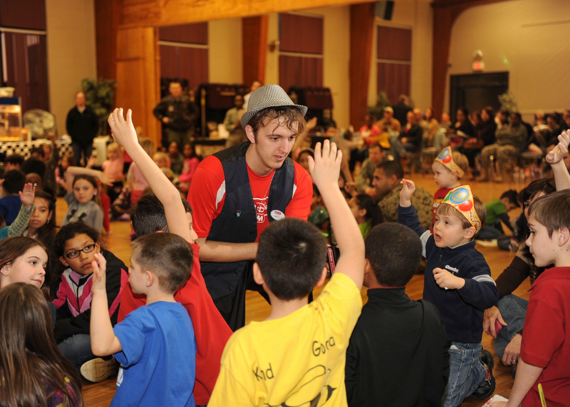 A Radio Disney member asks a group of children questions about the importance of saving money during Military Saves Week Feb. 28, 2013, at Little Rock Air Force Base’s Thomas Community and Activities Center. The Radio Disney members performed both songs and dances to help the children understand finance. (U.S. Air Force photo by Airman 1st Class Cliffton Dolezal)
