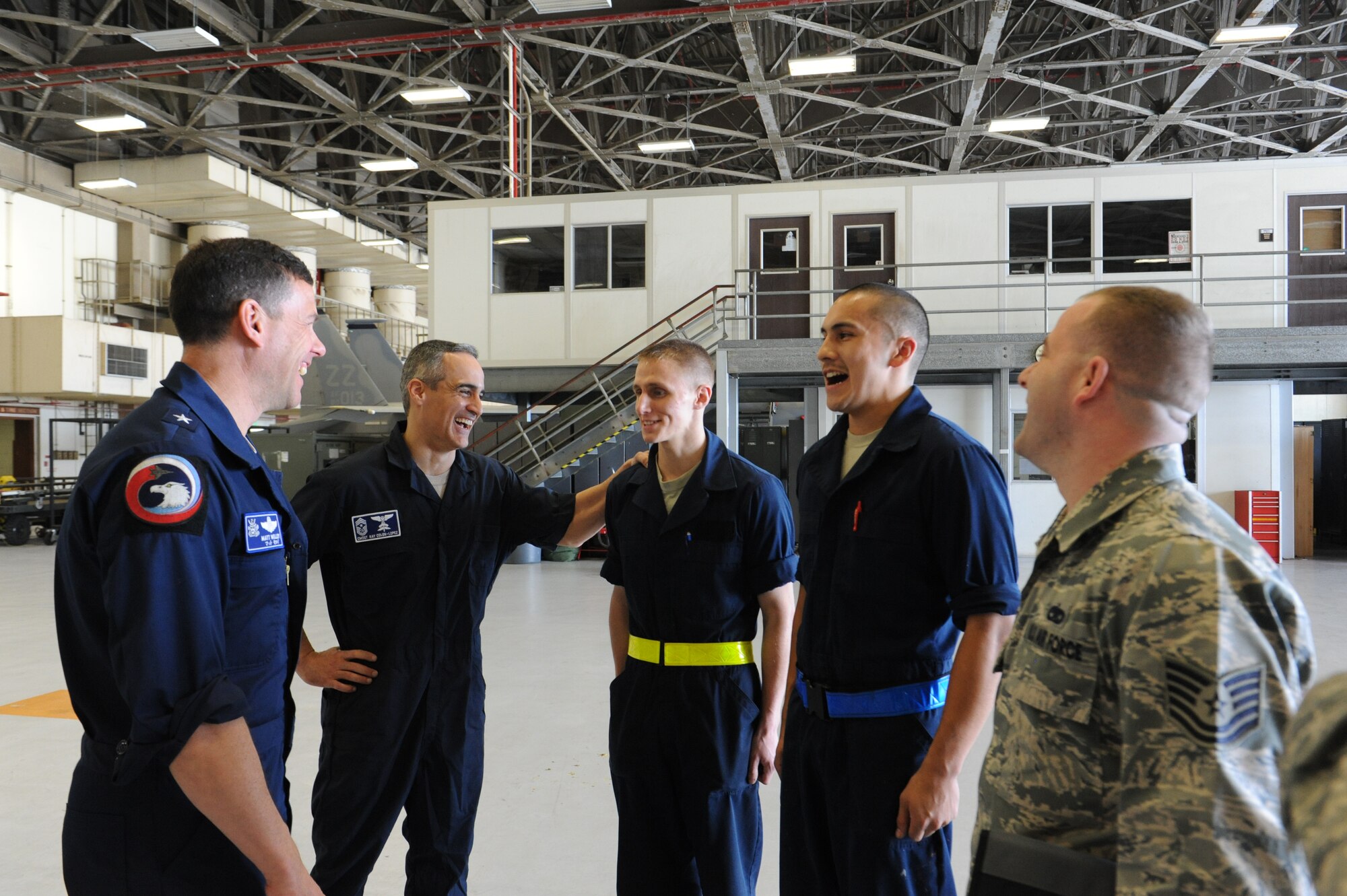 U.S. Air Force Brig. Gen. Matt Molloy, 18th Wing commander, and Chief Master Sgt. Ramon Colon-Lopez, 18th Wing command chief, interact with Airmen from the 18th Equipment Maintenance Squadron on Kadena Air Base, Japan, March 7, 2013. The Airmen briefed Kadena’s leadership about the proper safety precautions they would need to take before working on a U.S. Air Force F-15 Eagle fighter aircraft. (U.S. Air Force photo/Airman 1st Class Malia Jenkins)