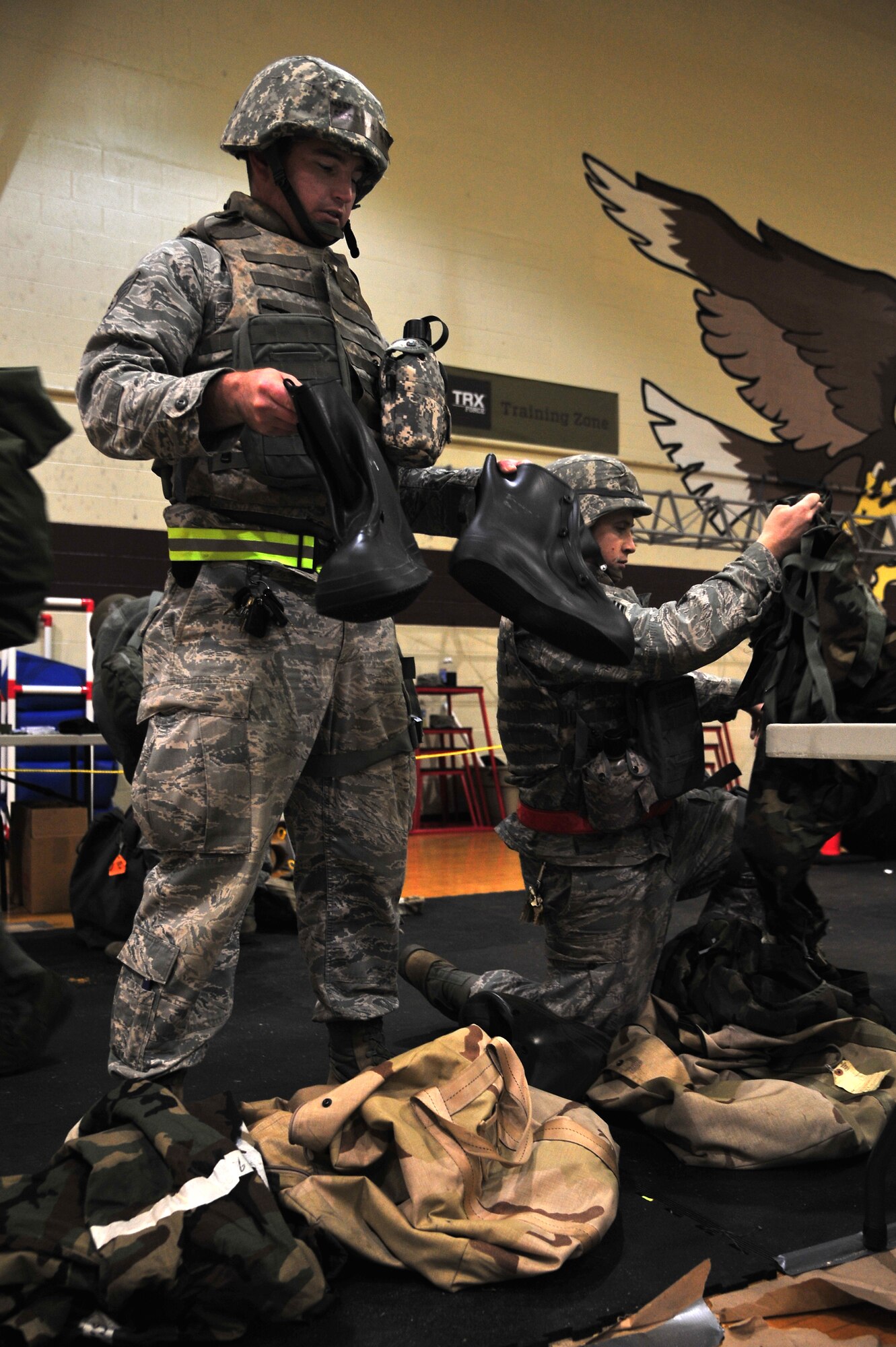U.S. Air Force Staff Sgt. Travis Smith, 4th Civil Engineer Squadron heavy equipment operator, checks his overboots for the appropriate “training” markings during Operational Readiness Inspection CORONET WHITE, at a simulated deployed location on Seymour Johnson Air Force Base, N.C., Mar. 7, 2013. Prior to arriving at the simulated deployed location, Airmen must process through the transition area to ensure they have all of the necessary equipment to survive and operate. (U.S. Air Force photo/Airman 1st Class Aubrey White/Released)