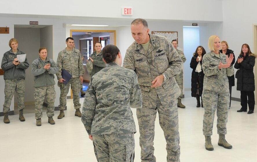 Maj. Gen. William Bender, U.S. Air Force Expeditionary Center commander, congratulates Staff Sgt. Alexandra Crawley, Grand Forks Air Force Base Honor Guard NCO in charge, after announcing that she was named the 2012 USAF Expeditionary Center Honor Guard Member of the Year, during a visit to the North Dakota base on Feb. 22, 2013. Bender surprised Crawley with the good news during his visit. (U.S. Air Force photo/Airman 1st Class Xavier Navarro)