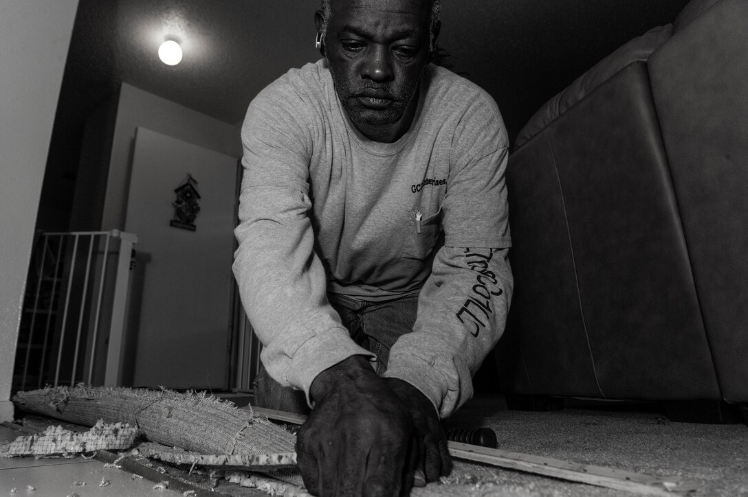 Robert Carson, a service contractor for GCC Enterprises, Inc., of 1st Special Operations Civil Engineer Squadron, fixes the edge of a carpet that came lose at base housing on Hurlburt Field, Fla., Jan. 28, 2013. Carson’s hard work and dedication aided him in becoming a skilled carpenter and eventually a superintendent for GCC Enterprises, Inc. (U.S. Air Force photo/Airman 1st Class Christopher Callaway)
