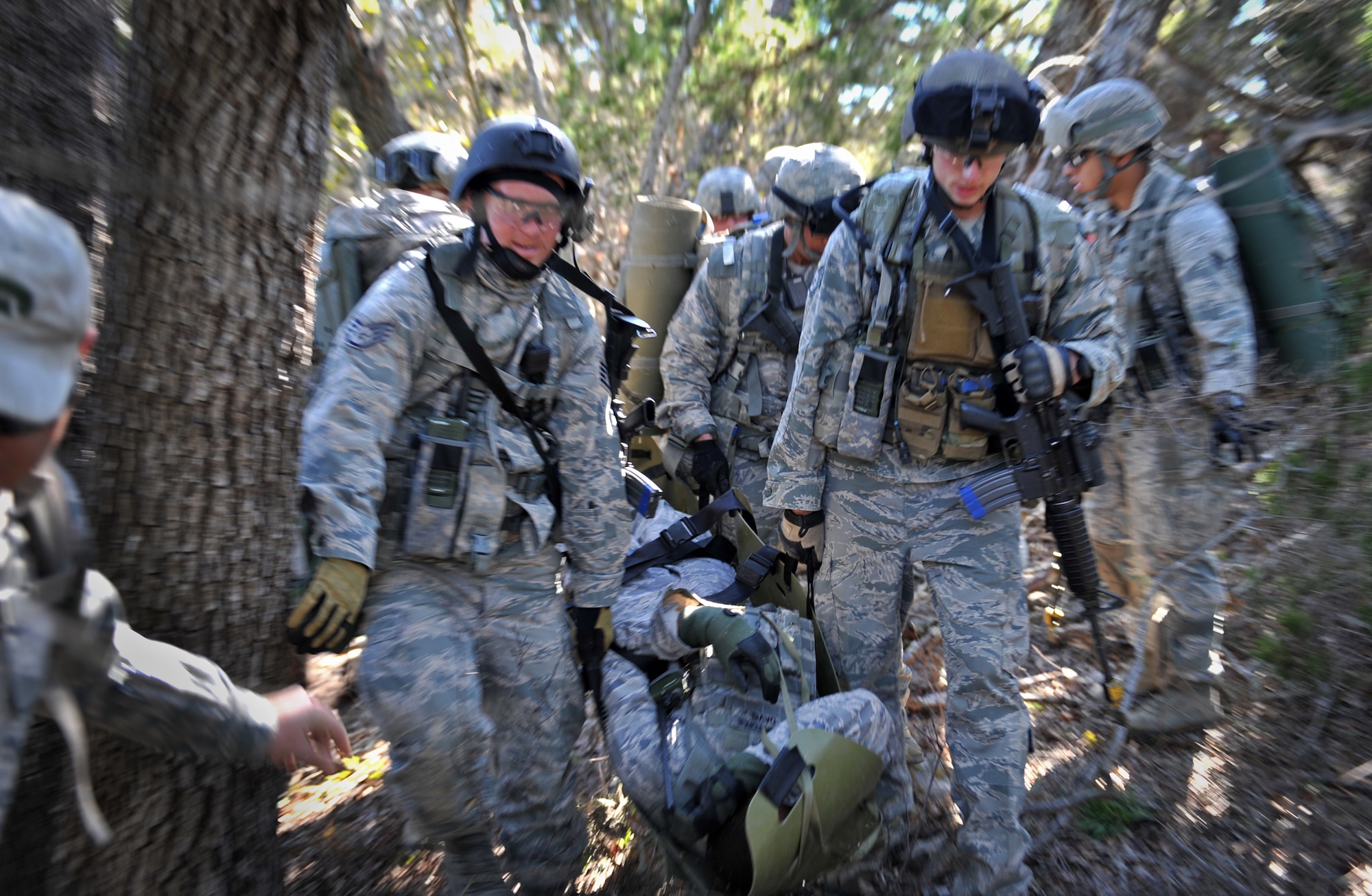 Staff Sgt. Craig Davis, noncommissioned officer in charge of pass and registration for the 18th Security Forces Squadron, is carried on a litter in order to get him to a combat medical aid station as a result of mock injuries during the training. Davis spent 26 days in February attending the Combat Leadership Course, Level II, at Joint Base San Antonio-Camp Bullis, Texas. He and 42 Security Forces Airmen spent the six weeks learning Security Forces operations and practical field skills such as moving as teams and squads, as well as conducting missions in the field. The course is taught several times during the year through the Security Forces Academy, part of the 343rd Training Squadron at JBSA-Lackland. (U.S. Air Force photo by Senior Airman Matthew Fredericks/Released)