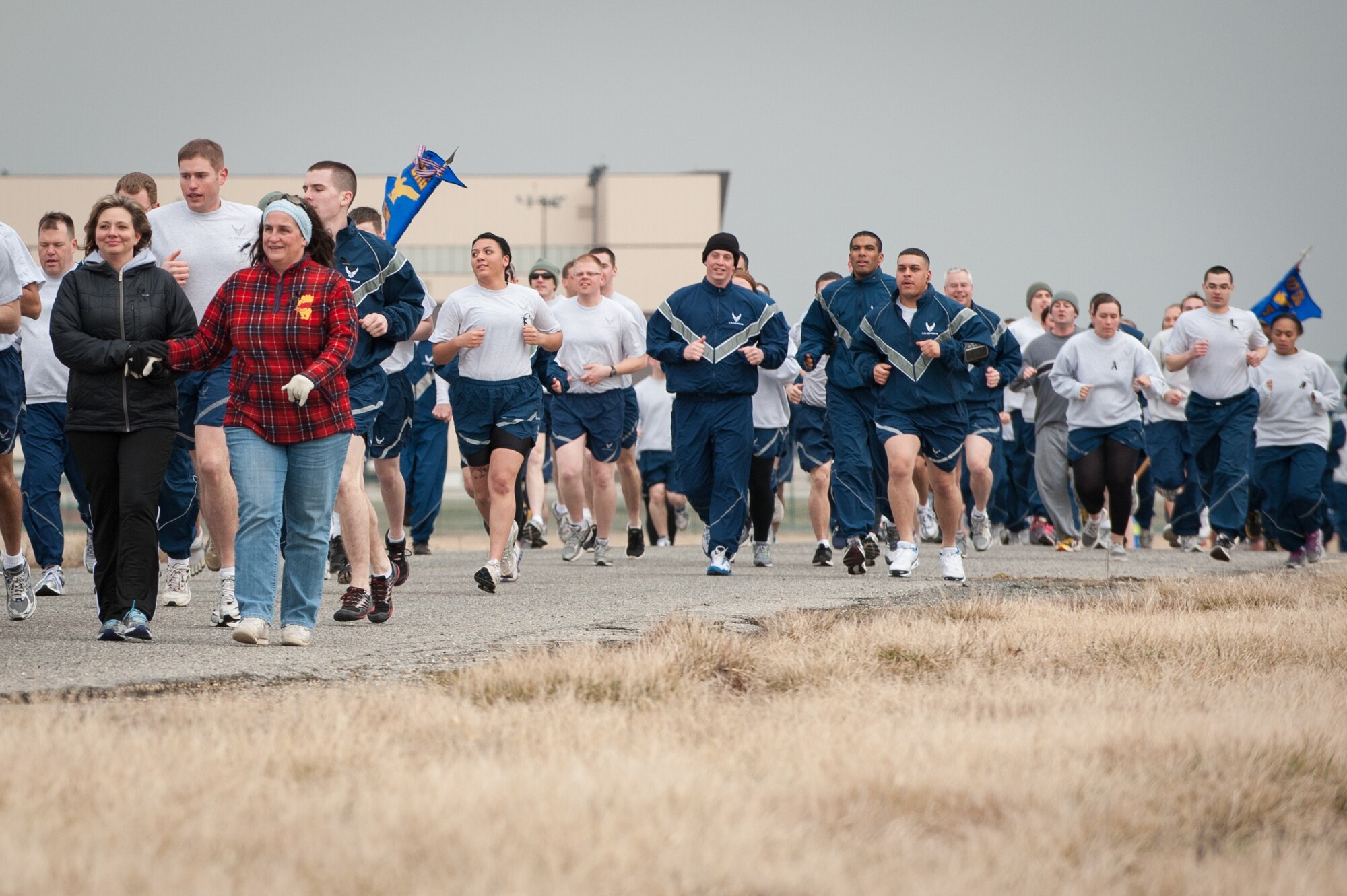 Cristine Circello (center left), escorts Sharon Loving, aunt of Tech. Sgt. Curtis Evan Eccleston, former 621st Contingency Response Wing member, during the 1.5-mile Eccleston Memorial Run Feb. 28, 2013, on Joint Base McGuire-Dix-Lakehurst, N.J. More than 100 joint base community members participated in the run. Eccleston, who hailed from Columbia, Md., was murdered Feb. 6, 2011, at Kadena Air Base, Japan. Circello is the spouse of Senior Master Sgt. Augustine Circello, 305th Aerial Port Squadron superintendent of ramp services. (U.S. Air Force photo by Russ Meseroll/Released)