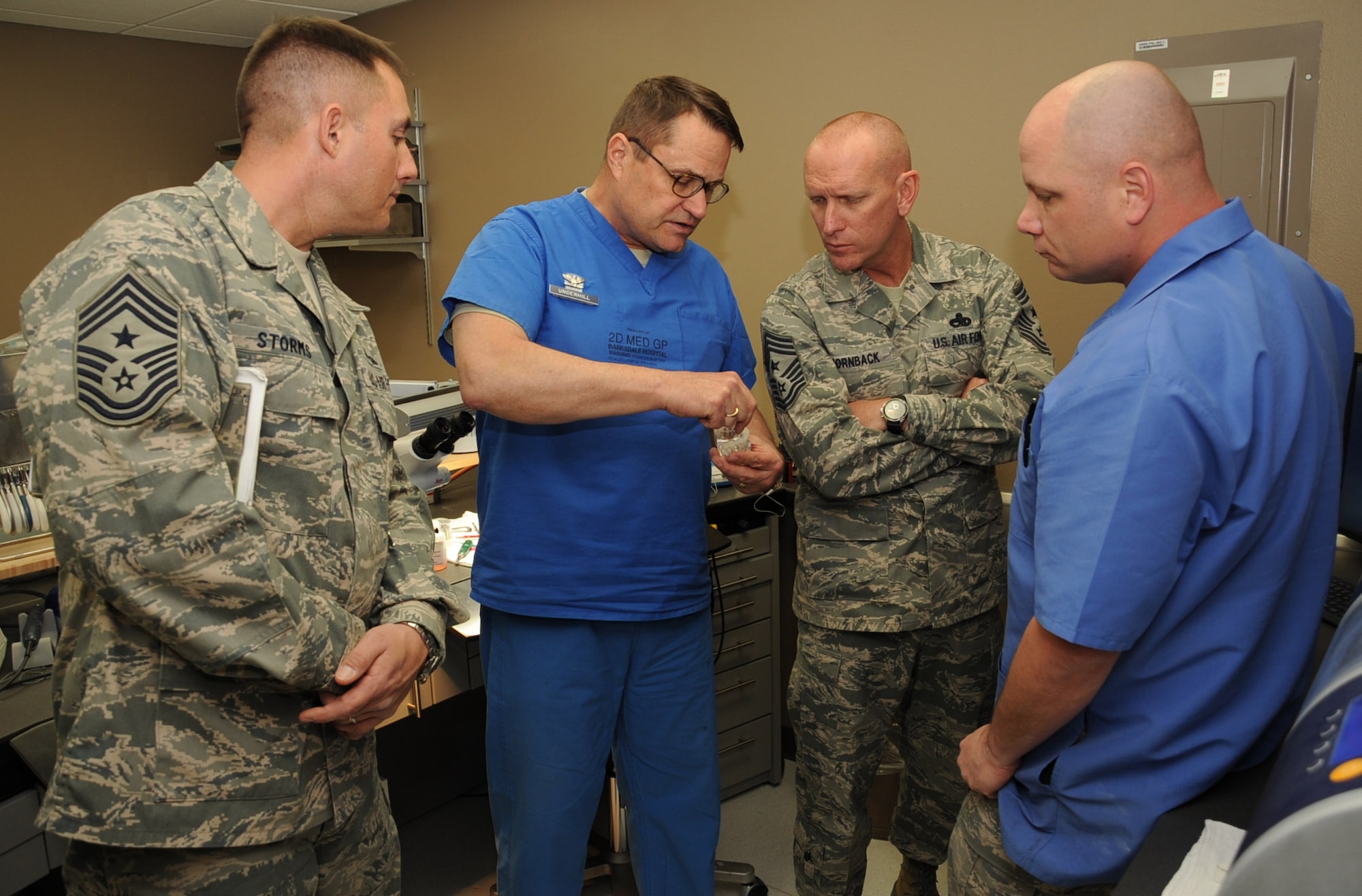 Col. Luke Underhill, 2nd Dental Squadron deputy commander, shows Chief Master Sgt. Brian Hornback, Command Chief of Air Force Global Strike Command, a crown that was made by 2 DS Airmen on Barksdale Air Force Base, La., March 5. During his tour of the 2nd Bomb Wing, Hornback met with various Airmen and squadrons to discuss any concerns or issues they had. (U.S. Air Force photo/Senior Airman Sean Martin)