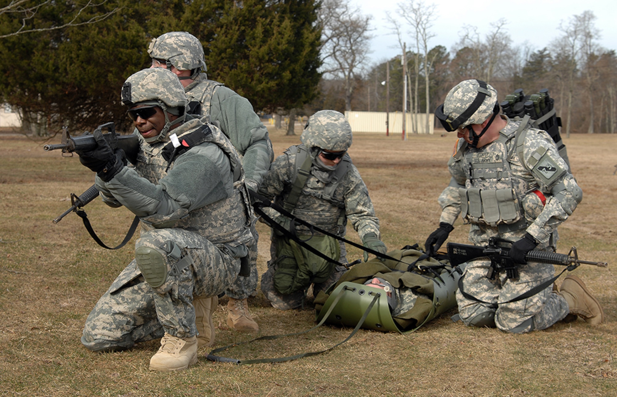Staff Sgt. Antron Ambrose, 847th Human Resources Company NCO, provides security for the field training experience during the Dix Combat Lifesaver Course Feb. 22, 2013, on Joint Base McGuire-Dix-Lakehurst, N.J. The course instructors recently received new first gear provided by First Army which will allow first responders to train on the same equipment they would use down range to save wounded warriors. (U.S. Army photo by David Moore/Released)