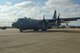 An aircrew member of the 136th Airlift Wing waves goodbye to the families gathered together prior to their departure for Southwest Asia on board the Wing's C-130 aircraft at NAS Fort Worth JRB, Texas, Feb. 26, 2013. The Airmen will support the Air Expeditionary Forces in Southwest Asia from 60 to 180 days.. (National Guard photos by Senior Master Sgt. Elizabeth Gilbert)