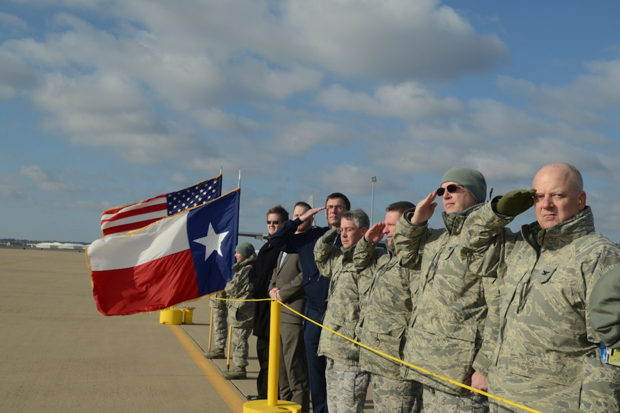 Texas State Legislative Representatives and Airmen of the 136th Airlift Wing salute the departing C-130 aircraft carrying the deploying Airmen to Southwest Asia at NAS Fort Worth JRB, Texas, Feb. 26, 2013. The Airmen will support the Air Expeditionary Forces in Southwest Asia from 60 to 180 days. (National Guard photos by Senior Master Sgt. Elizabeth Gilbert)