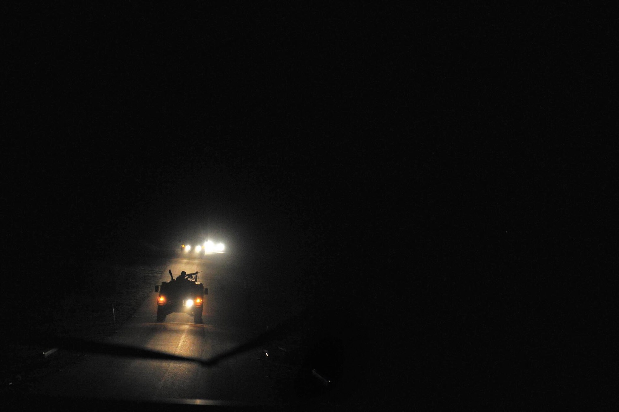 Military vehicles convoy Security Forces Airmen during a night-training mission. The Airmen spent 26 days in February attending the Combat Leadership Course, Level II, at Joint Base San Antonio-Camp Bullis, Texas. A total of 42 Security Forces Airmen spent the six weeks learning Security Forces operations and practical field skills such as moving as teams and squads, as well as conducting missions in the field. The course is taught several times during the year through the Security Forces Academy, part of the 343rd Training Squadron at JBSA-Lackland. (U.S. Air Force photo by Senior Airman Matthew Fredericks/Released)