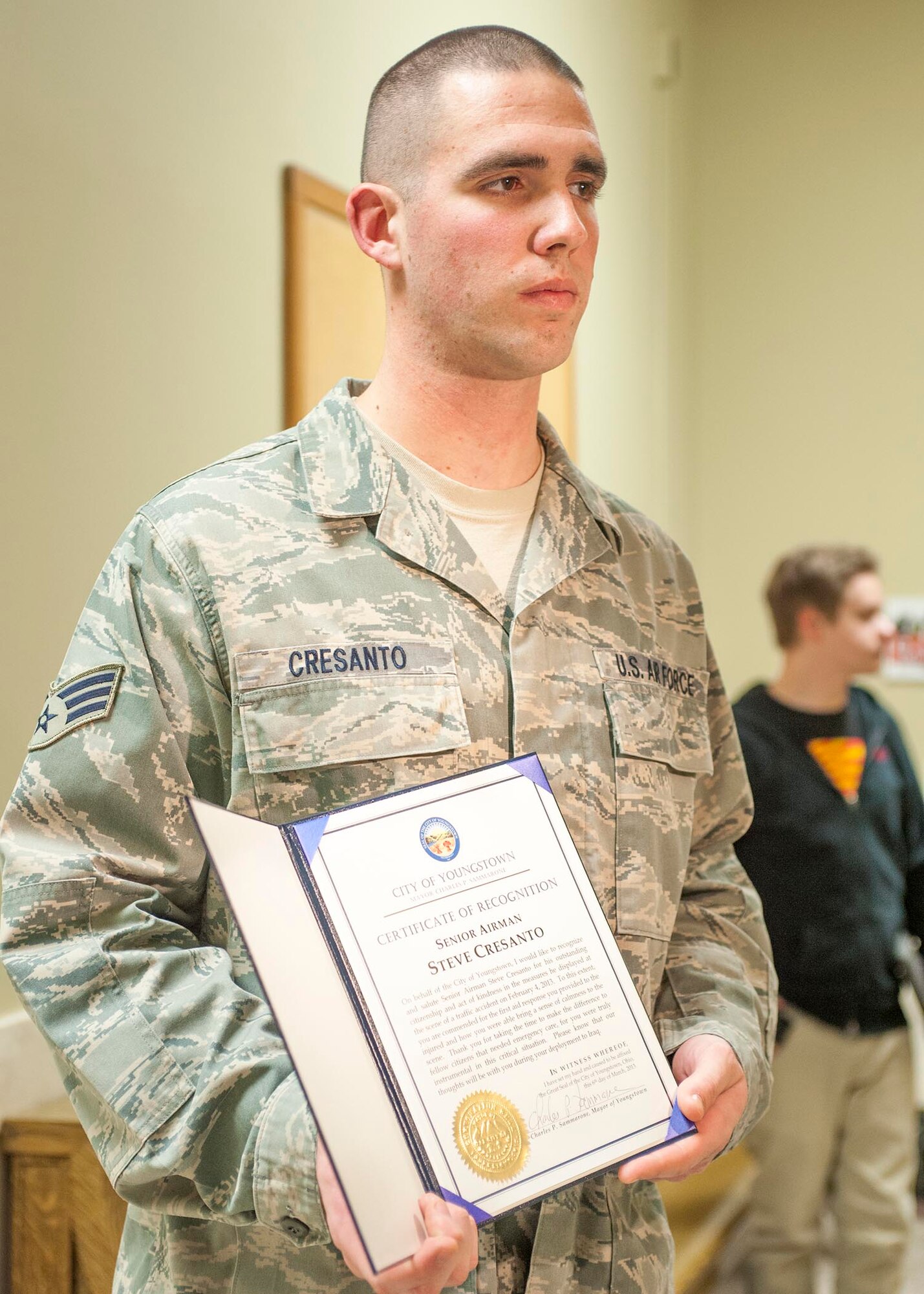 YOUNGSTOWN CITY HALL, Ohio—Air Force Reserve Senior Airman Steve Cresanto holds the award presented to him by Youngstown City Mayor Charles Sammarone at a city council meeting here, March 6. The award recognizes heroic actions Cresanto took on the scene of a motor vehicle accident Feb. 5. Cresanto used his Air Force Self Aid Buddy Care training to treat two victims until first responders arrived, ultimately saving one man’s life.
