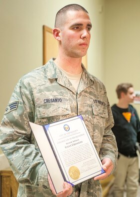 Senior Airman Steve Cresanto holds the award presented to him by Youngstown City Mayor Charles Sammarone at a city council meeting March 6, 2013, in Youngstown City, Ohio. The award recognizes heroic actions Cresanto took on the scene of a motor vehicle accident Feb. 5, 2013. Cresanto used his Air Force Self Aid Buddy Care training to treat two victims until first responders arrived, ultimately saving one man’s life. Cresanto is an air transportation journeyman with Youngstown Air Reserve Station's 76th Aerial Port Squadron. (Courtesy photo)
