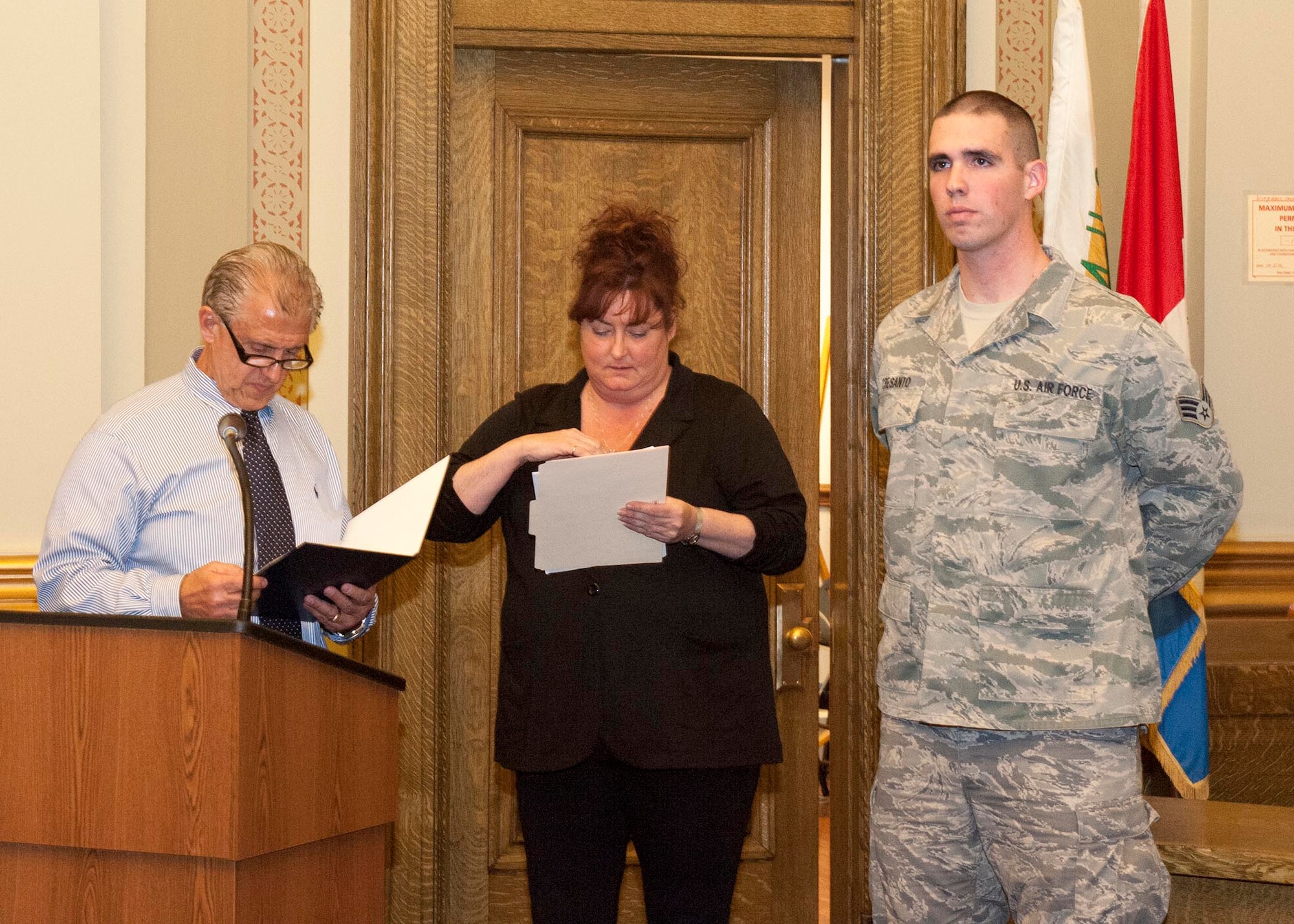YOUNGSTOWN CITY HALL, Ohio—Youngstown City Mayor Charles Sammarone (left) reads the citation accompanying an award presented to Air Force Reserve Senior Airman Steve Cresanto (right) here, March 6. The award, presented at a city council meeting, recognizes heroic actions Cresanto took on the scene of a motor vehicle accident Feb. 5. Cresanto used his Air Force Self Aid Buddy Care training to treat two victims until first responders arrived, ultimately saving one man’s life.