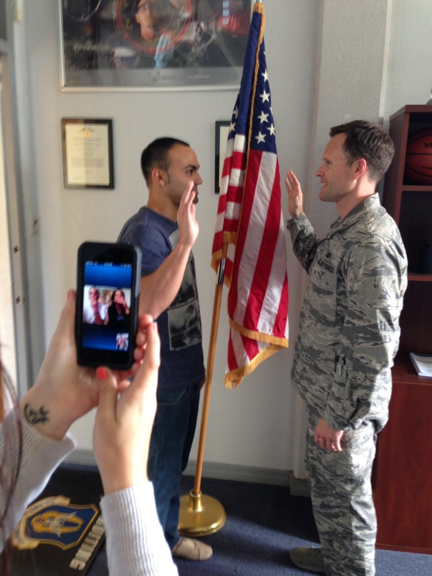 Trainee Christian Lopez takes his oath of enlistment at MacDill Air Force Base, Fla. while his parents watch live from Italy via skype (Air Force photo by MSgt Dominque Hogan)