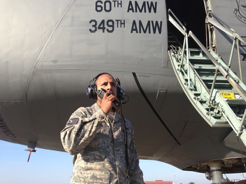 Tech. Sgt. Jose Ramon, 60th Aircraft Maintenance Squadron flightline expediter and 18th Air Force NCO of the year, communicates aircraft status and servicing level updates to the maintenance operations center Feb. 12 for input into the integrated maintenance data system for mobility. (courtesy photo)  